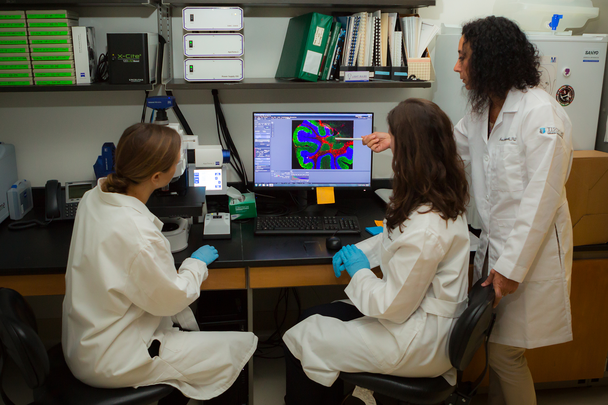 3 scientists study data on a computer screen